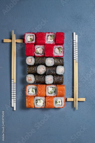Sushi Set nigiri and sushi rolls on gray stone slate on metal background