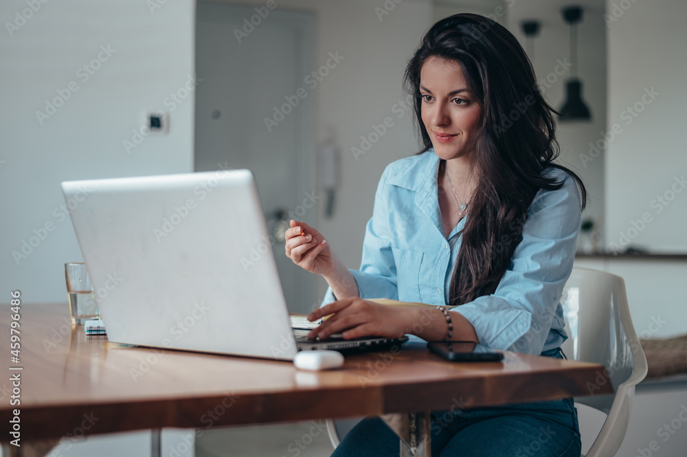 Businesswoman using laptop while working in the office Businesswoman using laptop while working in the office