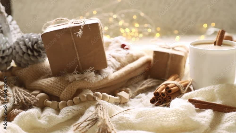 someone taking a gift box, scandinavian style cozy morning with some knitted blankets, cacao mug, gift box, winter and festive mood, cristmas vibe. High quality FullHD footage someone taking a gift box, scandinavian style cozy morning with some knitted blankets, cacao mug, gift box, winter and festive mood, cristmas vibe. High quality FullHD footage