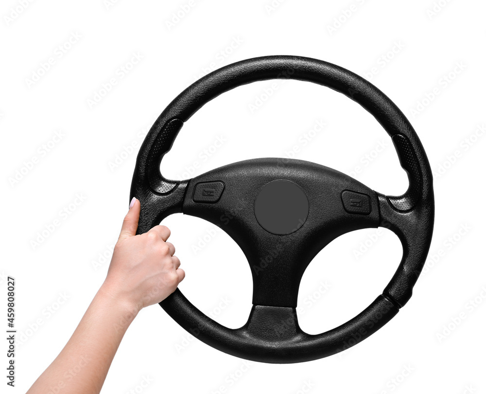Female hand and steering wheel on white background