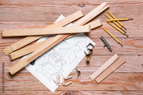 Furniture assembling plan and tools on wooden background