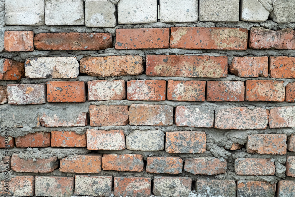 Red brick wall, real wall of an old brick house, close-up Red brick wall, real wall of an old brick house, close-up
