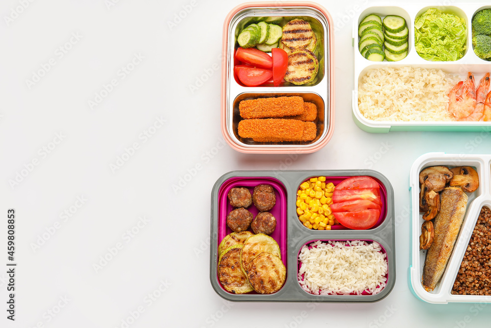 Containers with different food on white background, closeup Containers with different food on white background, closeup