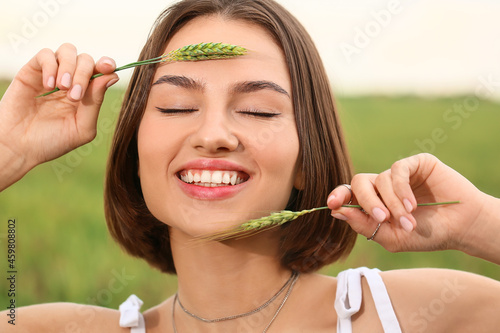Beautiful young woman in field