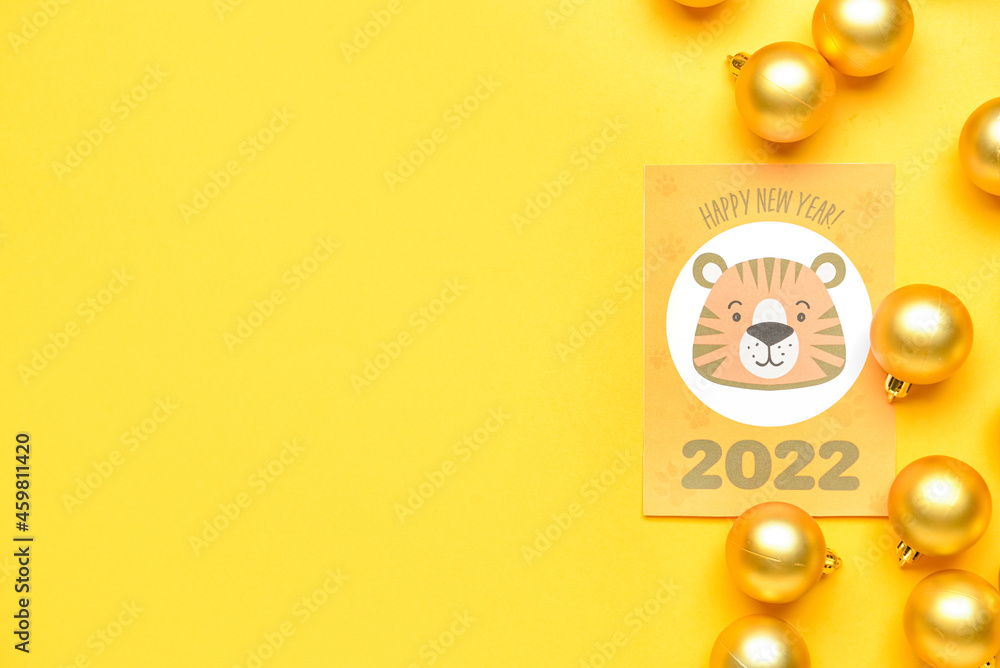 Greeting card for New Year 2022 celebration with balls on color background Greeting card for New Year 2022 celebration with balls on color background