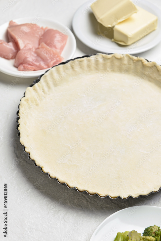 Raw dough and ingredients for preparing pot pie on light background Raw dough and ingredients for preparing pot pie on light background