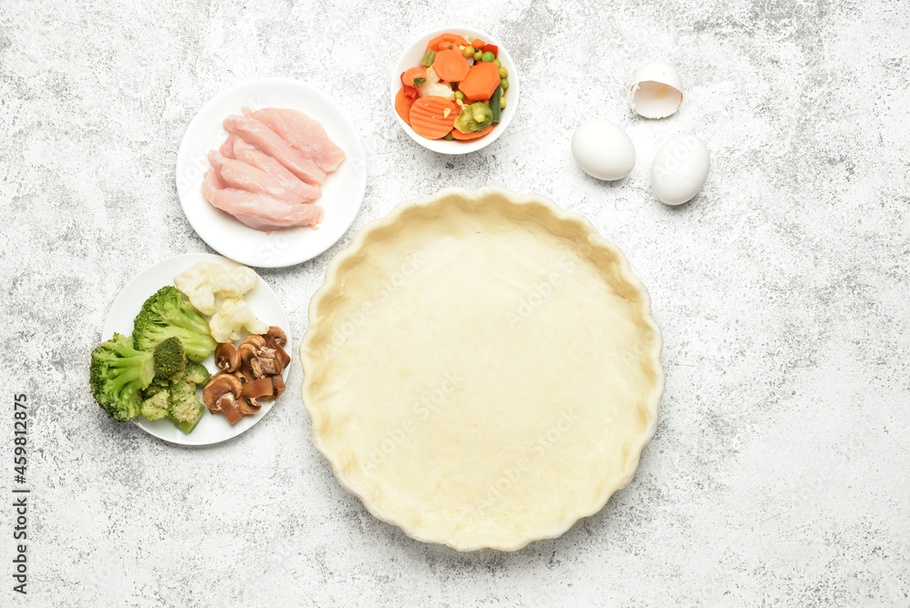 Raw dough and ingredients for preparing pot pie on light background Raw dough and ingredients for preparing pot pie on light background