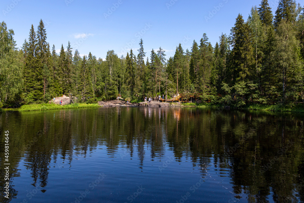 People at Ruskeala waterfalls on the Tohmayoki river in the Republic of Karelia in Russia People at Ruskeala waterfalls on the Tohmayoki river in the Republic of Karelia in Russia