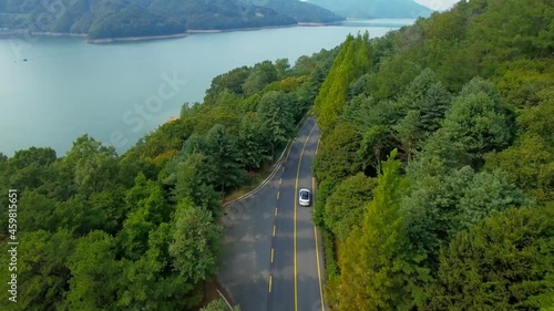 Aerial view of white car driving on riverside road in forest. South Korea.
호숫가 도로 드라이브.