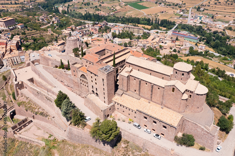 Scenic summer view from drone of medieval fortress with romanesque Church of Sant Vicenc on hilltop in Spanish town of Cardona, Catalonia