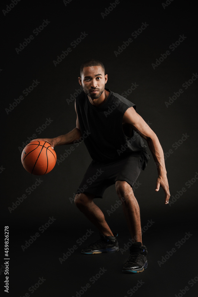 Young bristle sportsman playing basketball while working out Young bristle sportsman playing basketball while working out