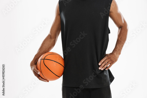 Young black sportsman posing with basketball © Drobot Dean