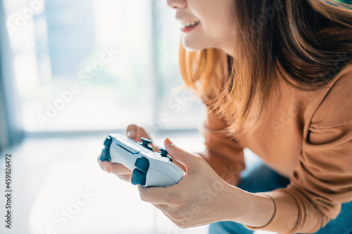 Closeup Hand of woman playing a computer games with joystick, copy space.