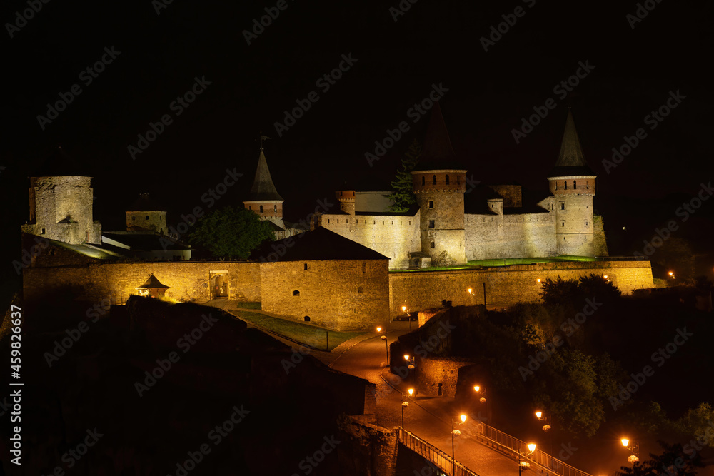 Night panoramic view of medieval castle in Kamenetz-Podolsk (Kamianets-Podilskyi), Ukraine
