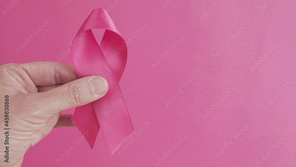 hands holding pink ribbons, Breast cancer awareness and October Pink day