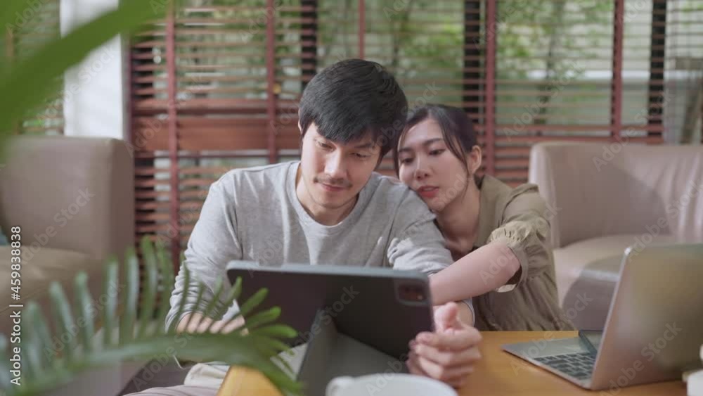 home finance,husband and wife discussing paper bill receipt together on the floor at living room with focus and concentrate feeling with about family debt home interior background home finance,husband and wife discussing paper bill receipt together on the floor at living room with focus and concentrate feeling with about family debt home interior background