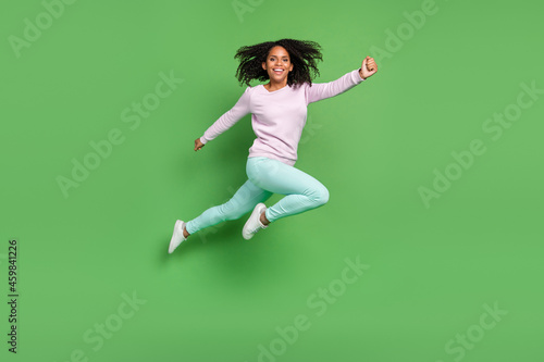 Full size photo of cute millennial brunette lady jump wear pullover pants shoes isolated on blue background