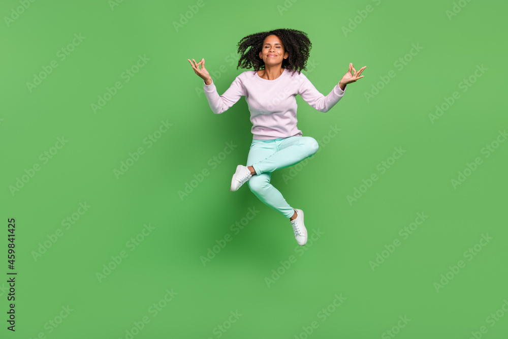 Full length photo of nice young brunette lady jump wear pullover pants shoes isolated on blue background Full length photo of nice young brunette lady jump wear pullover pants shoes isolated on blue background