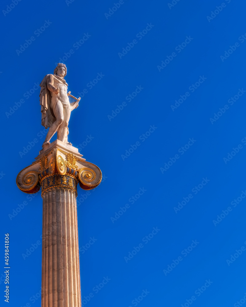 Apollo the ancient Greek god of poetry and music under blue sky with space for your text, Athens Greece Apollo the ancient Greek god of poetry and music under blue sky with space for your text, Athens Greece
