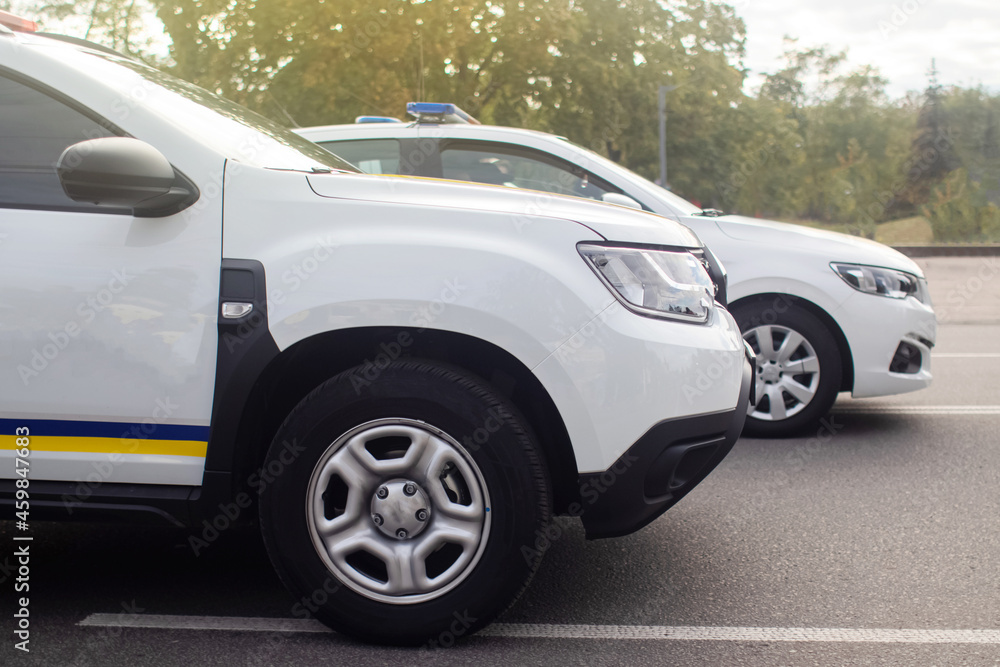 Close-up of police cars without labels or markings. A parade of cars of the defenders of order and tranquility. The work of the special services. Place for text Close-up of police cars without labels or markings. A parade of cars of the defenders of order and tranquility. The work of the special services. Place for text