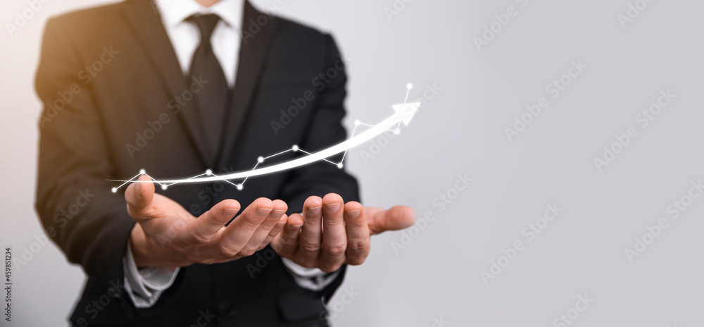 Fototapeta premium Businessman hold sales data and economic growth graph chart. Business planning and strategy. Analysing trading of exchange. Financial and banking. Technology digital marketing.Profit and growing plan.