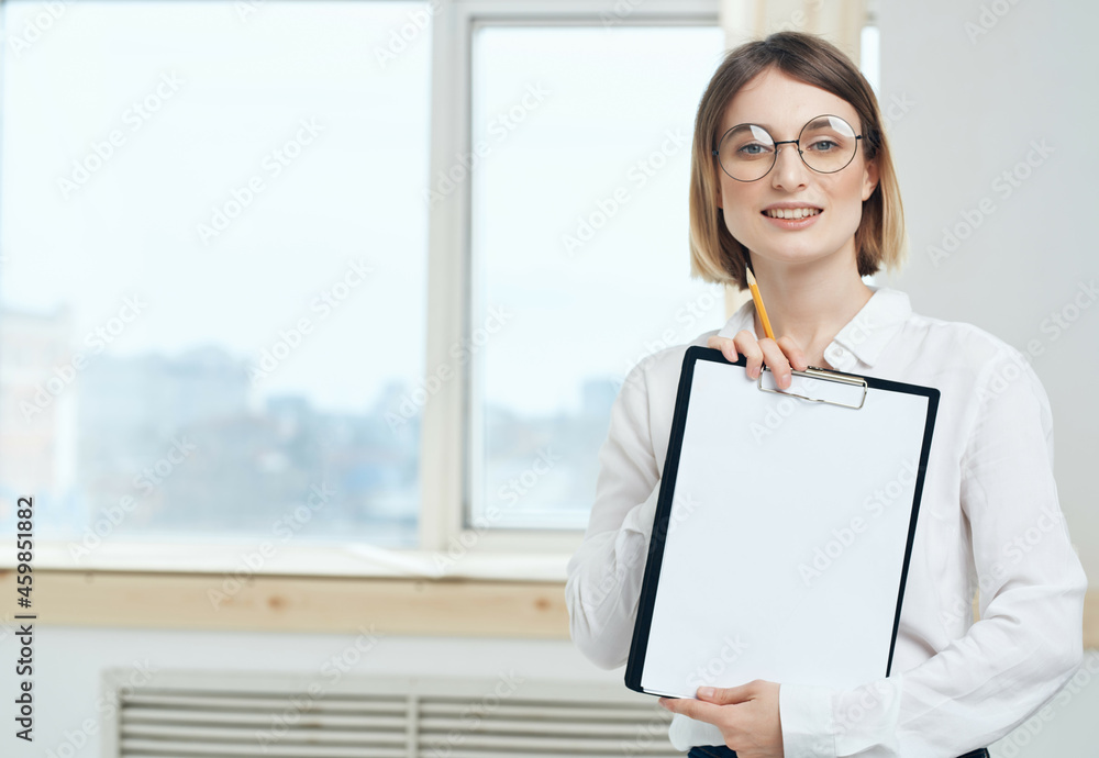 Business woman in white shirt and glasses near office manager window Business woman in white shirt and glasses near office manager window