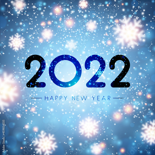 Fogged glass 2022 sign on bokeh snowflakes background.