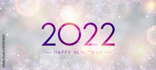 Fogged glass 2022 sign on bokeh snowflakes background..