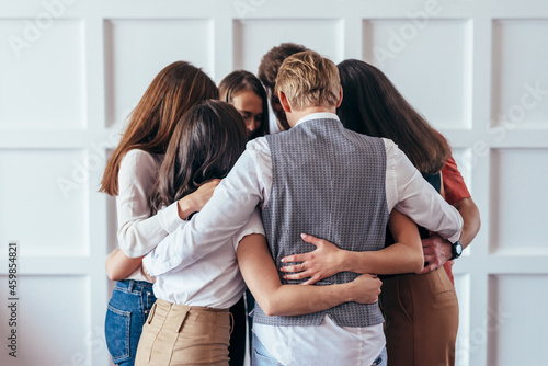 Psychological support, people are standing in circle and hugging.