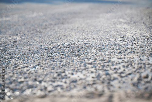 white and gray pebbles on a flat surface with blue shades, blur all around