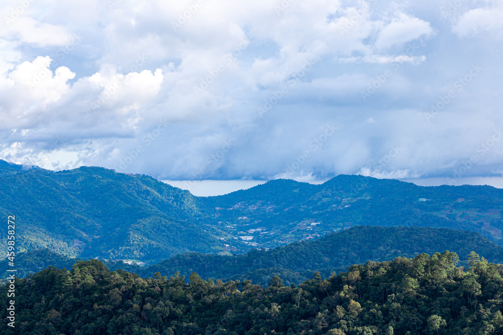 View of high hills and big clouds in the blue sky on Doi Mon Chaem, Chiang Mai, Thailand.