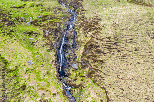 Aerial view of a waterfall in the mountains near Crolly in County Donegal - Ireland photo