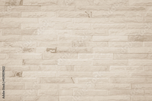 Empty background of wide cream brick wall texture. Beige old brown brick wall concrete or stone textured