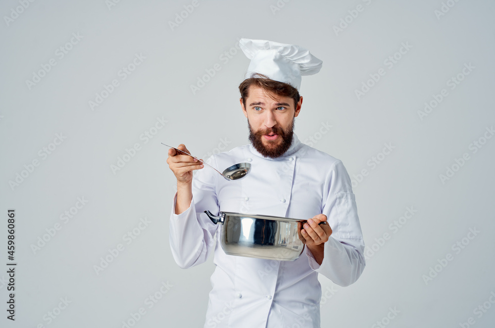 bearded male chef with a saucepan in his hands cooking food kitchen professional bearded male chef with a saucepan in his hands cooking food kitchen professional