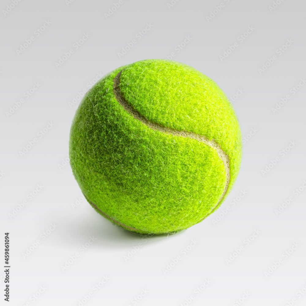 Bright yellow-green tennis ball on a light background