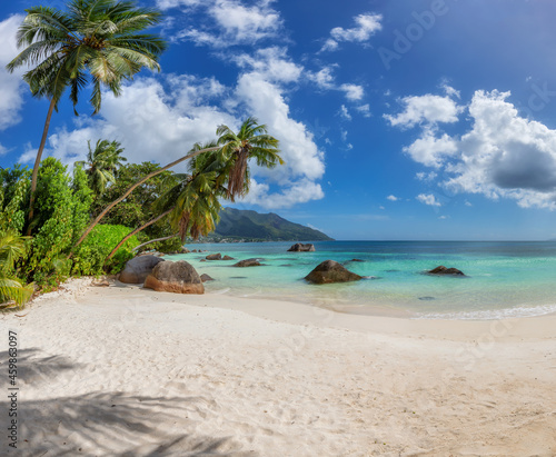 Exotic Sunny beach and coconut palms on Beau Vallon beach, Seychelles. 