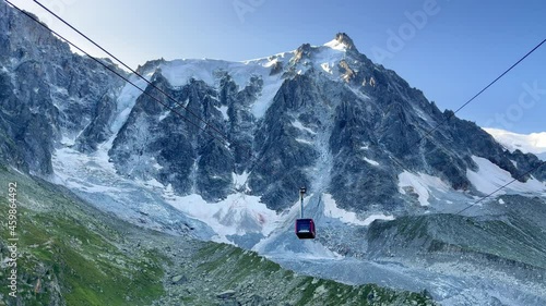4K Cable car moving suspended on steel cables descending from higher station up in the Alpine mountains. Travelling, nature, environment, transportation footage.