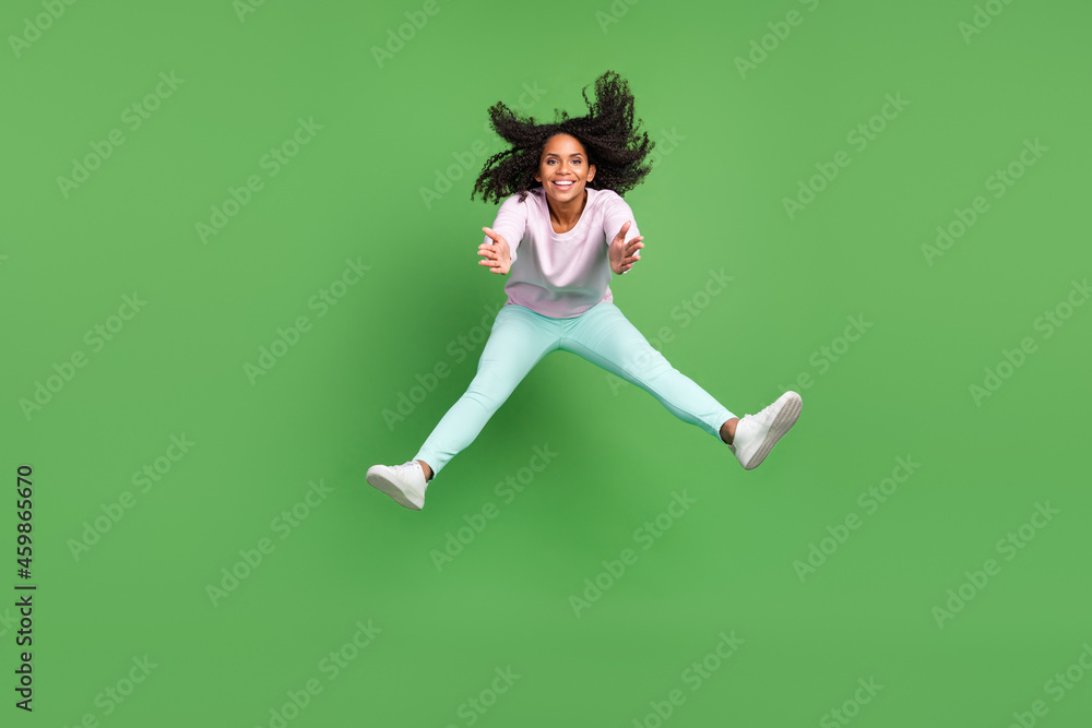 Full body photo of cool millennial brunette lady jump wear pullover pants shoes isolated on blue background Full body photo of cool millennial brunette lady jump wear pullover pants shoes isolated on blue background