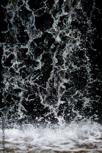 Water flow at short exposure on a dark background.