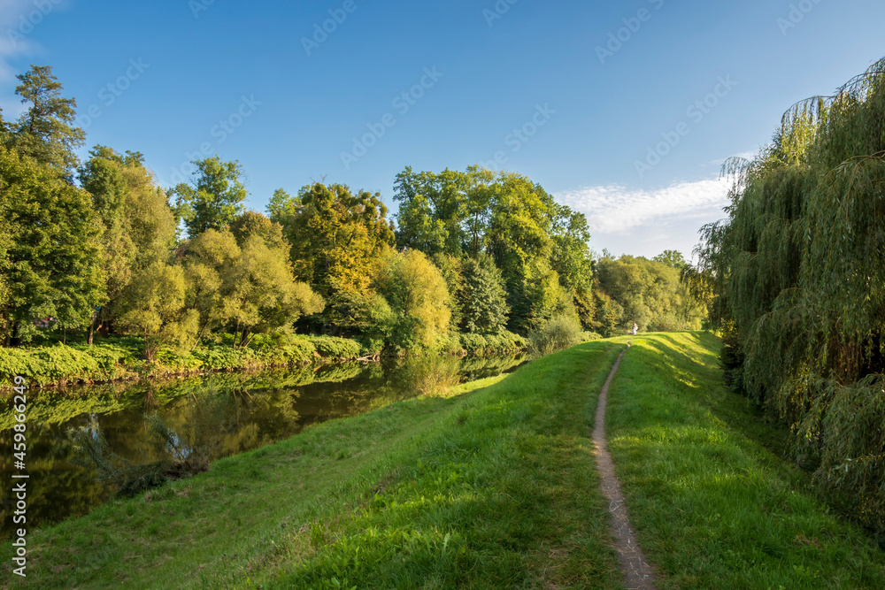 The road along the Olza embankment on the Czech side of the river on a sunny autumn afternoon