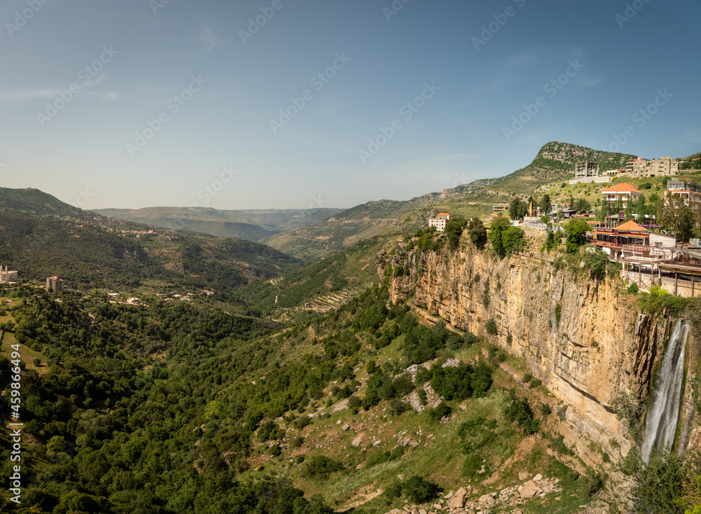 Panorama of Jezzine town and landscape with famous 90 meter high waterfall pouring into a dry valley, in Southern Lebanon, Middle East