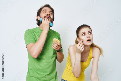 young couple in multicolored t-shirts hygiene facial care healthy morning