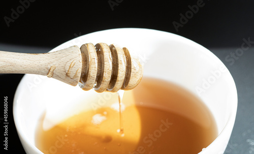 honey dripping from a wooden spoon