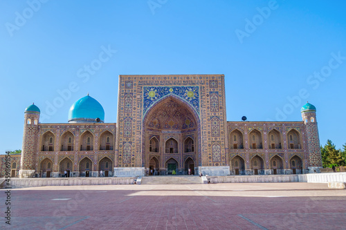 Facade of Tilya Kori Madrasah, one of the most famous and oldest buildings in Samarkand, Uzbekistan. Building is decorated with traditional Eastern ornaments and patterns
