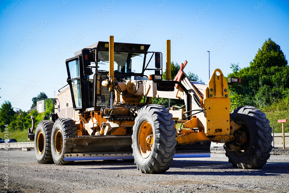 Road grader - heavy machine for earth moving and arrange the slope of the road Road grader - heavy machine for earth moving and arrange the slope of the road