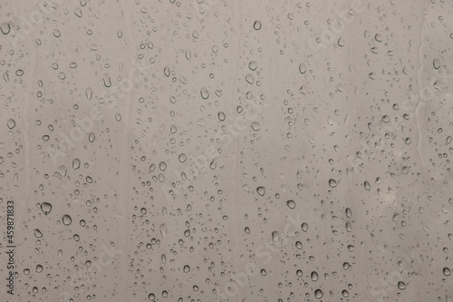 Obraz na płótnie Water rain drops on window glass surface with cloudy background for your design. Natural Pattern of raindrops on glass background. Copy space, No focus, specifically. w salonie
