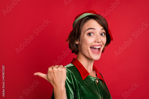 Profile side photo of young woman happy positive smile point thumb empty space season sale isolated over red color background
