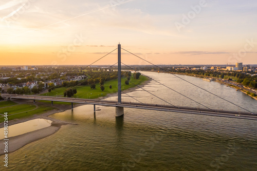 Germany, North Rhine-Westphalia, Dusseldorf, Aerial view of Oberkasseler Bridge at sunset photo