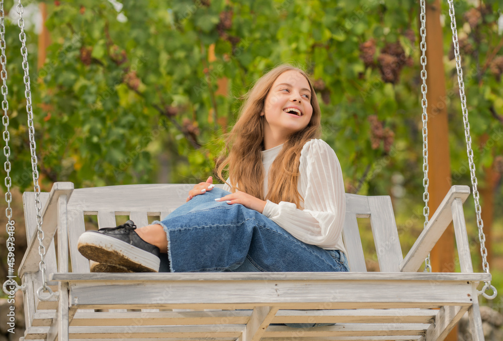 positive emotions. glad child on swing. kid swinging outdoor. teen girl having fun positive emotions. glad child on swing. kid swinging outdoor. teen girl having fun