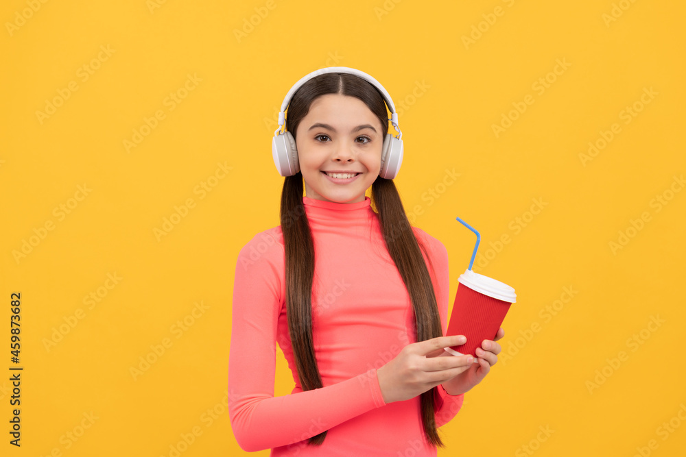 lets try. cheerful kid with takeaway coffee cup with headphones. good morning lets try. cheerful kid with takeaway coffee cup with headphones. good morning